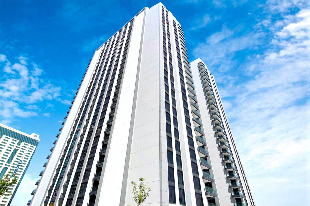 Exterior view of The Bridges by Aldar Properties on Reem Island, Abu Dhabi showcasing modern luxury apartments and waterfront design